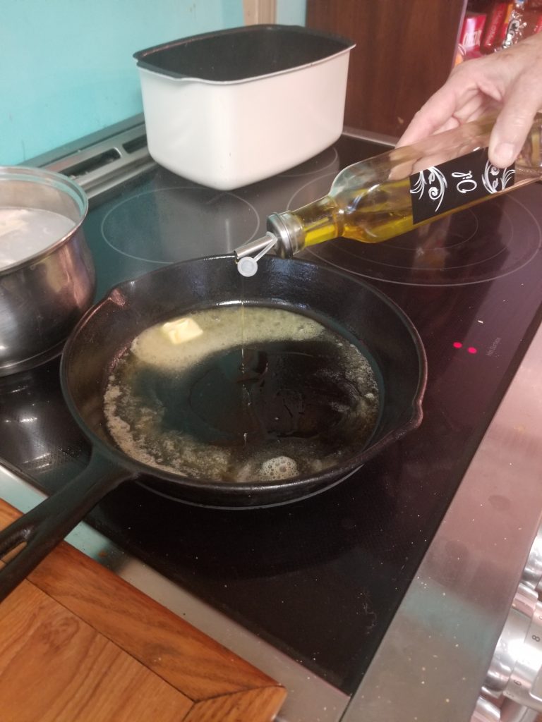 picture of cast iron pan with butter and live oil added